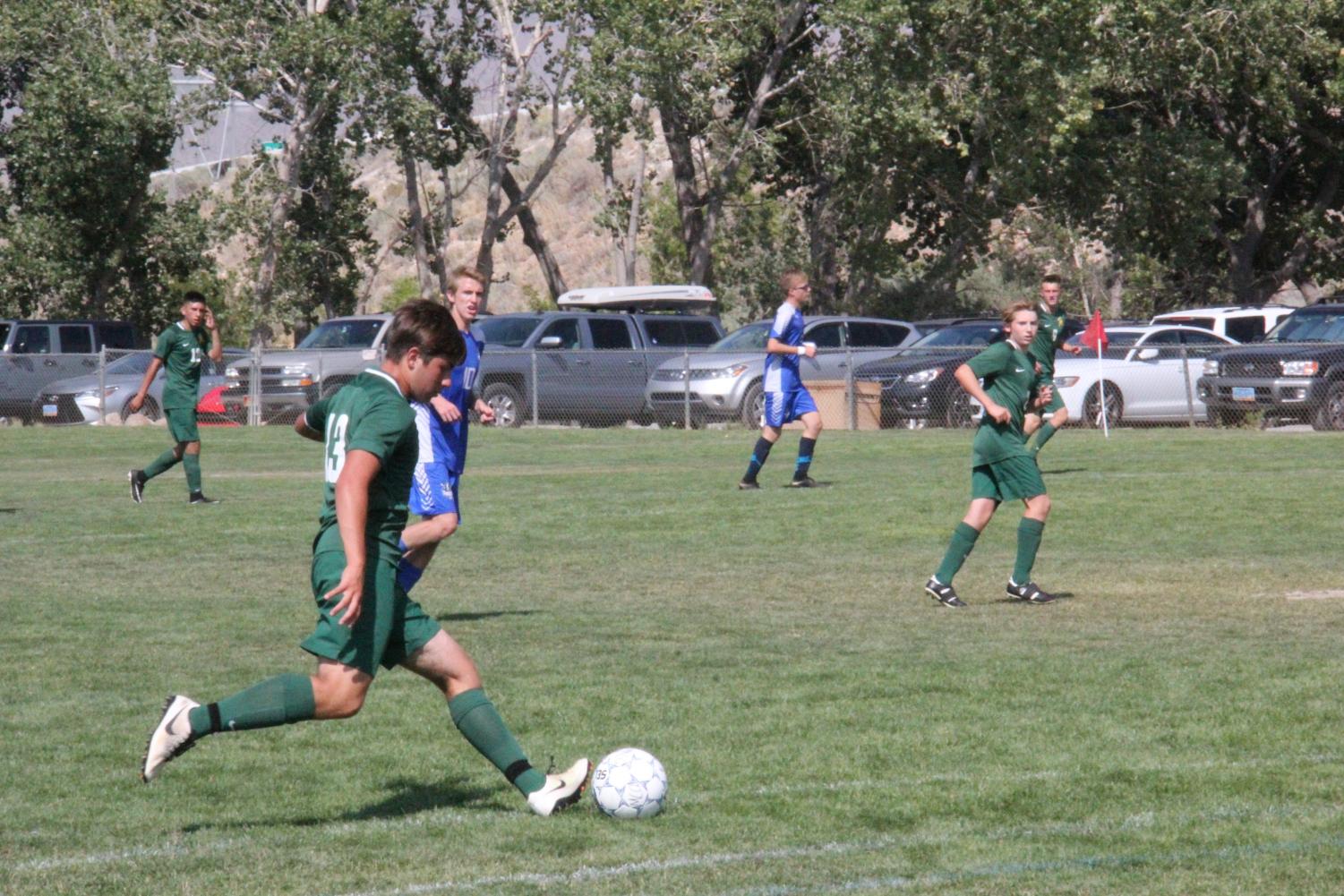 Captain, Benton Acosta, charges with the ball up the field. (Photo courtesy of the Bishop Manogue Yearbook Staff and Jackie Cavilia.)