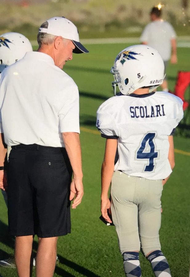 Scolari strategizing with his grandpa as a young football player. Photo courtesy of Drew Scolari.