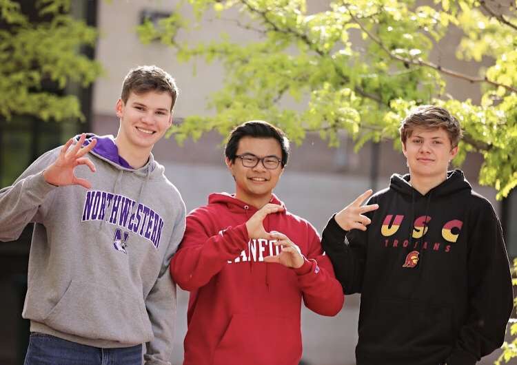Theodore Hall, Michael Hyashi, and Devon Riche pose in their college sweatshirts on a Senior Lunch Thursday as they make their final decisions. Photo courtesy of Devon Riche.