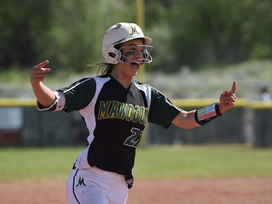 Senior Chelie Senini celebrates as she runs in toward home plate.  Photo courtesy of the Reno-Gazette Journal.
