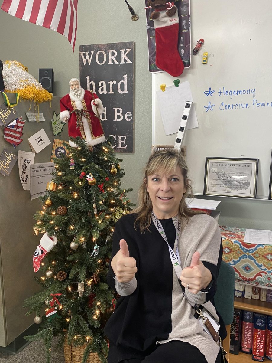 Mrs. Kersten gives us a double thumbs-up by the Christmas tree she keeps out all year!