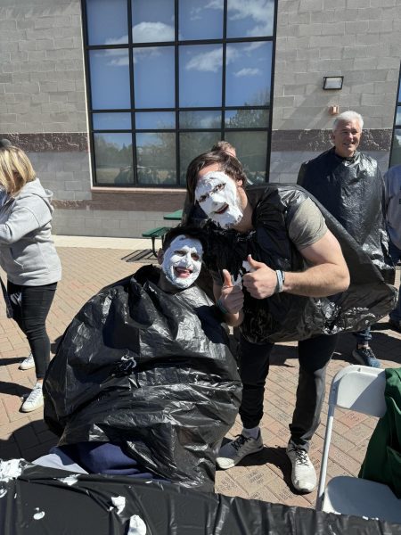 Coach Burg and Mr. Farnsworth smile for a picture after getting pied!