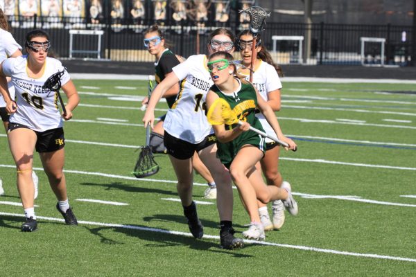 Sophomore Lyla Wiese running the ball down the field.  Game against Bishop Kelly.