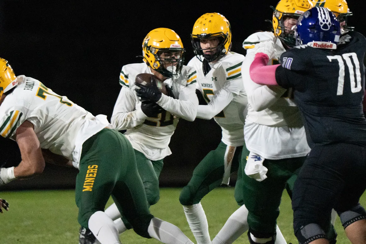 Junior quarterback Parker Scholl handing the ball to senior running back Evan Escovedo against Spanish Springs.